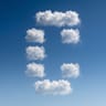 Clouds arranged in the shape of the Conductor logo against a blue sky